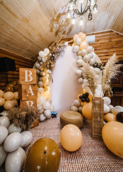 Birthday decorations - balloons, garland and decor for little baby party on a wall background. Celebration baptism concept.